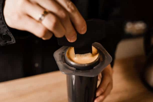 Cafetera Aeropress colocada sobre una taza de café durante la preparación